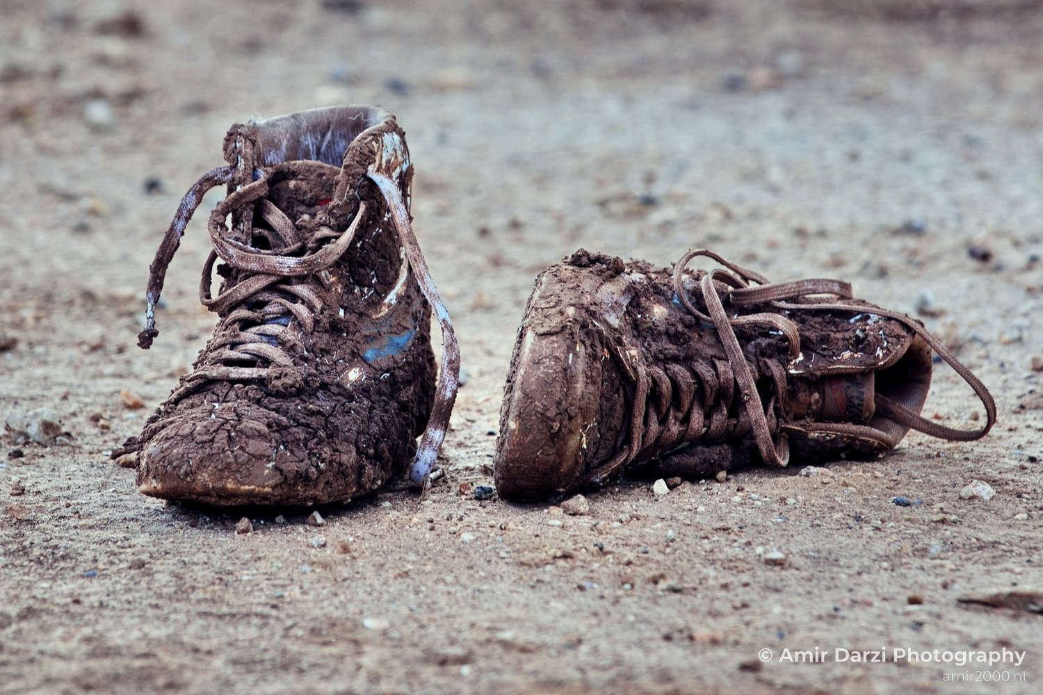 Abandoned shoes covered in mud around the field Miscellaneous in General Photography Collection Photo 1