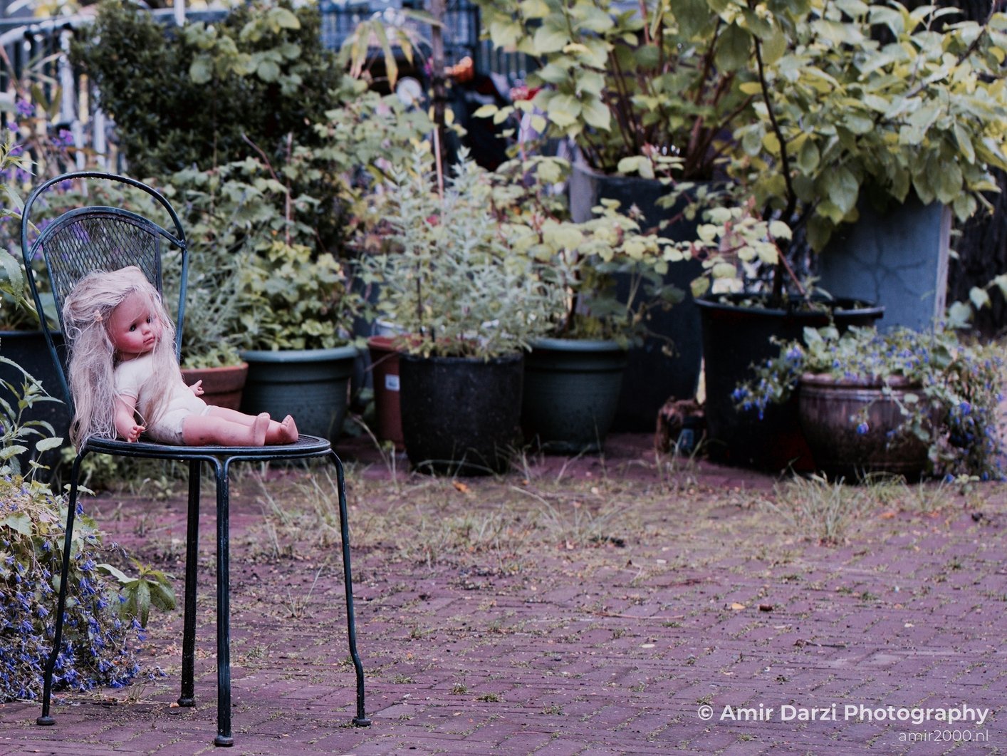 Doll sitting on a chair street Miscellaneous in General Photography Collection