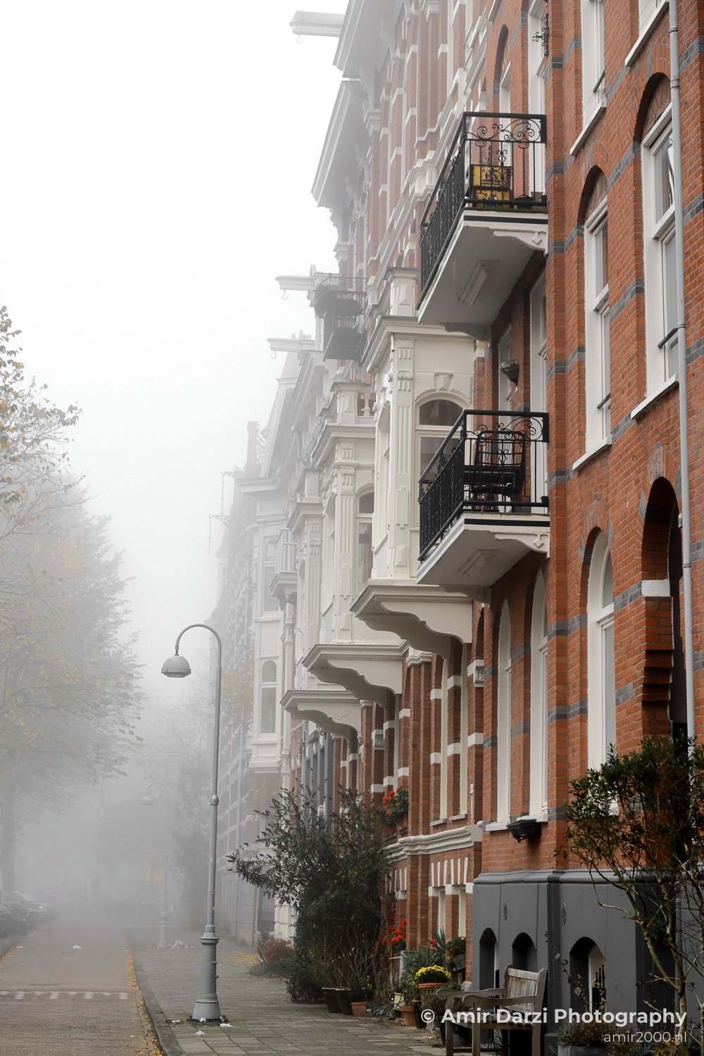 Foggy scenic pathway Alexanderkade near canal Amsterdam fall Urban Street Cityscape Netherlands in Amsterdam Netherlands