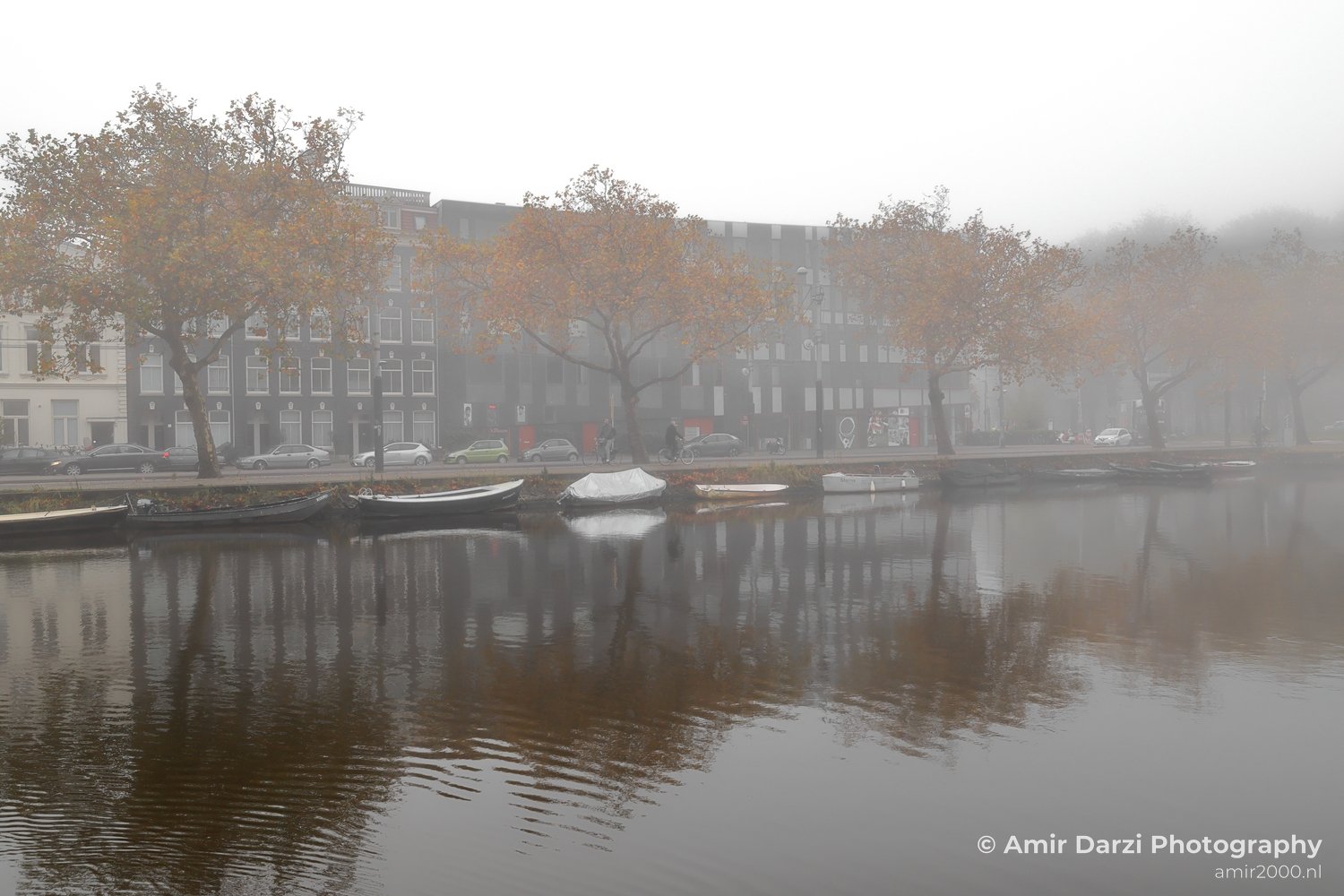 Mauritskade Canal boats in foggy scenery Amsterdam fall Urban Street Cityscape Netherlands in Amsterdam Netherlands