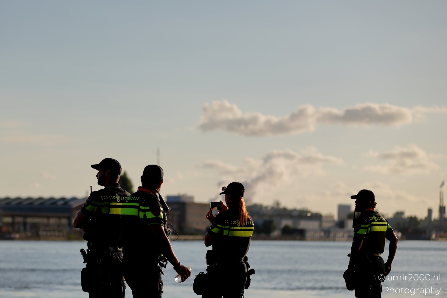 Dutch Police officers silhouette waterfront Sail 2025 750 to the city Amsterdam Netherlands People Creative from People Creative Collection series