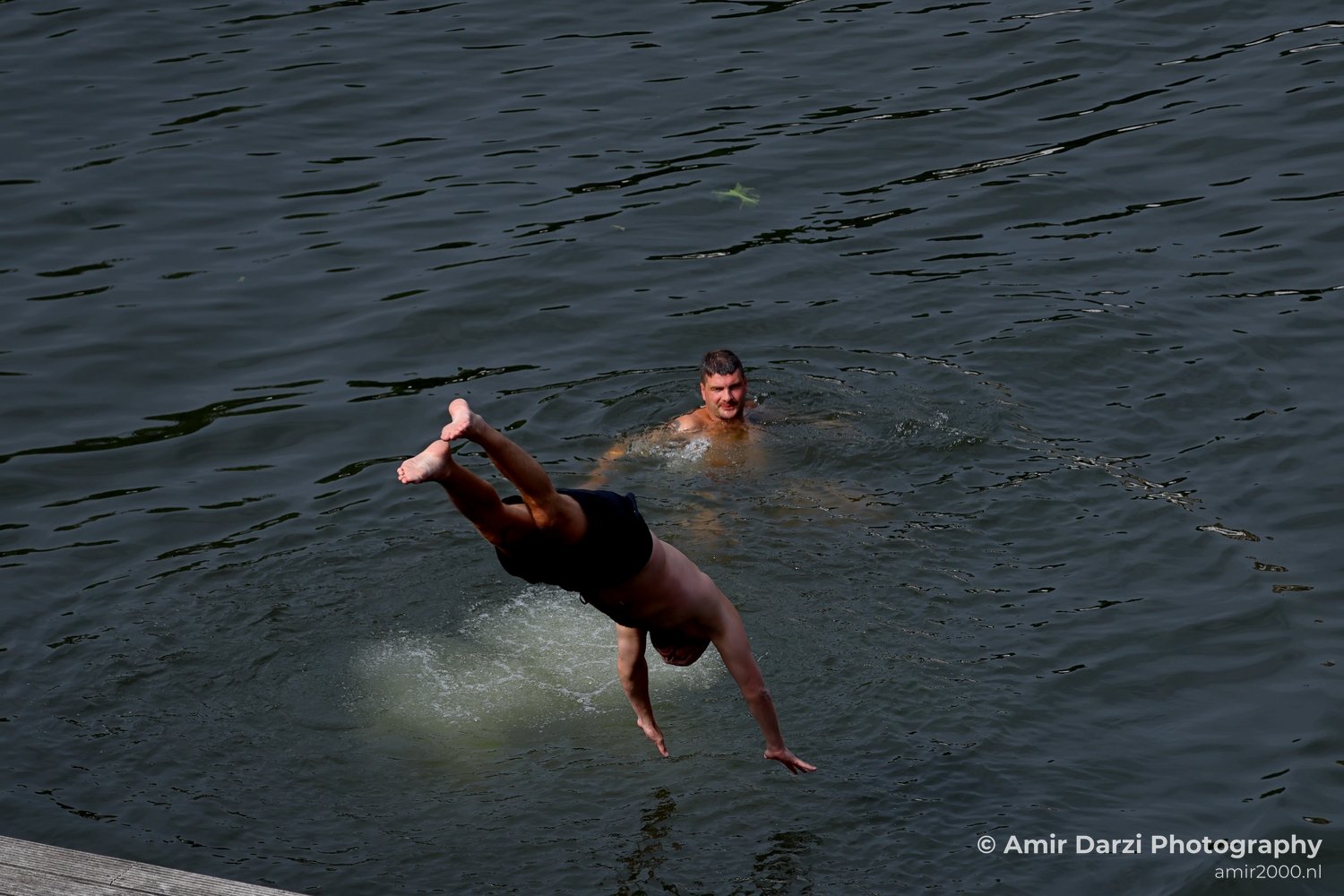 Jumping to the canal in Amsterdam Netherlands from People Creative Collection series Photo 2