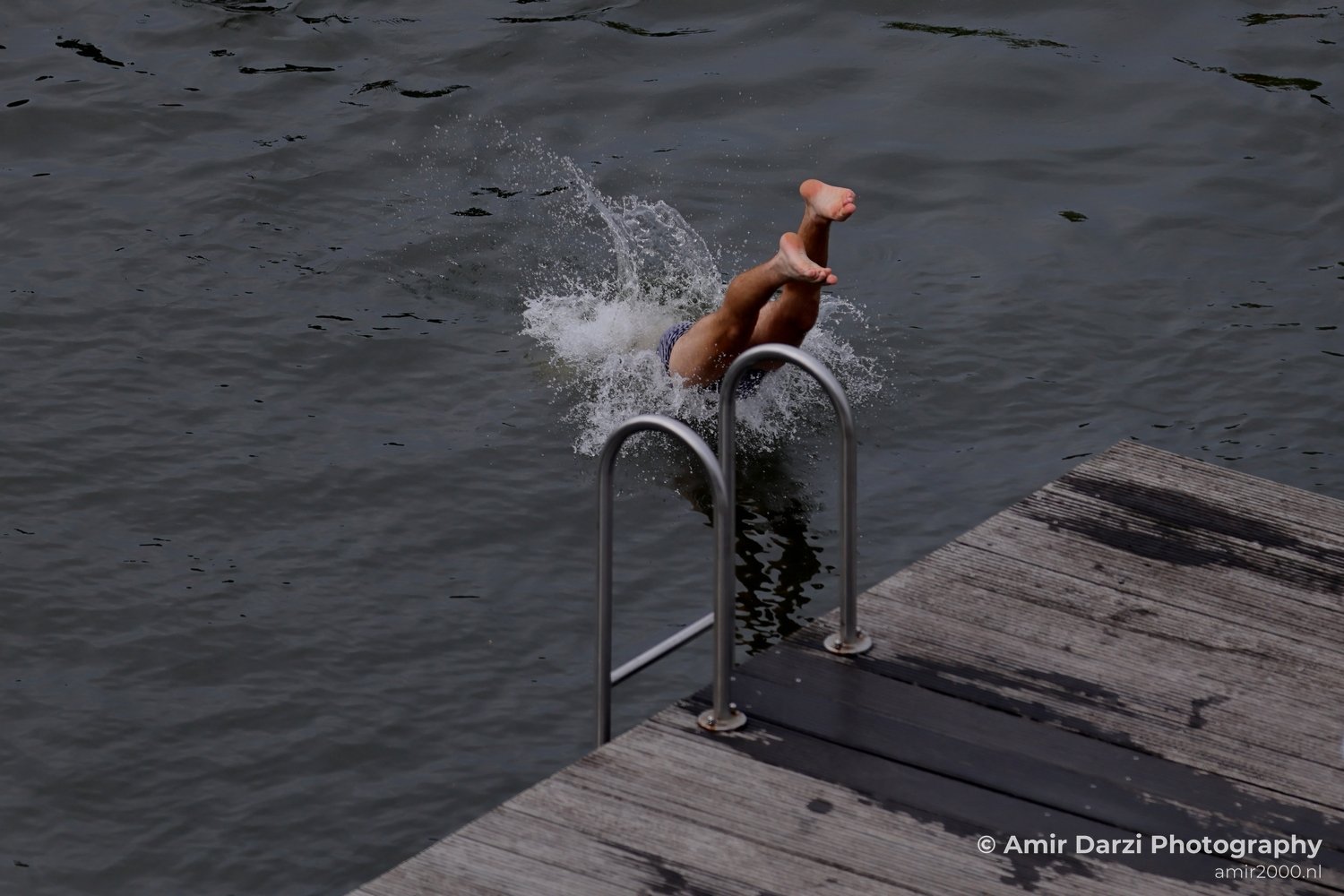 Jumping to the canal in Amsterdam Netherlands from People Creative Collection series Photo 16