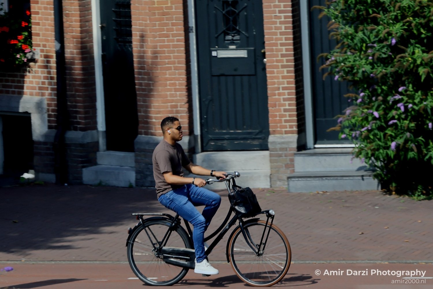 Man Riding Bicycle in the city Amsterdam Netherlands People Creative from People Creative Collection series