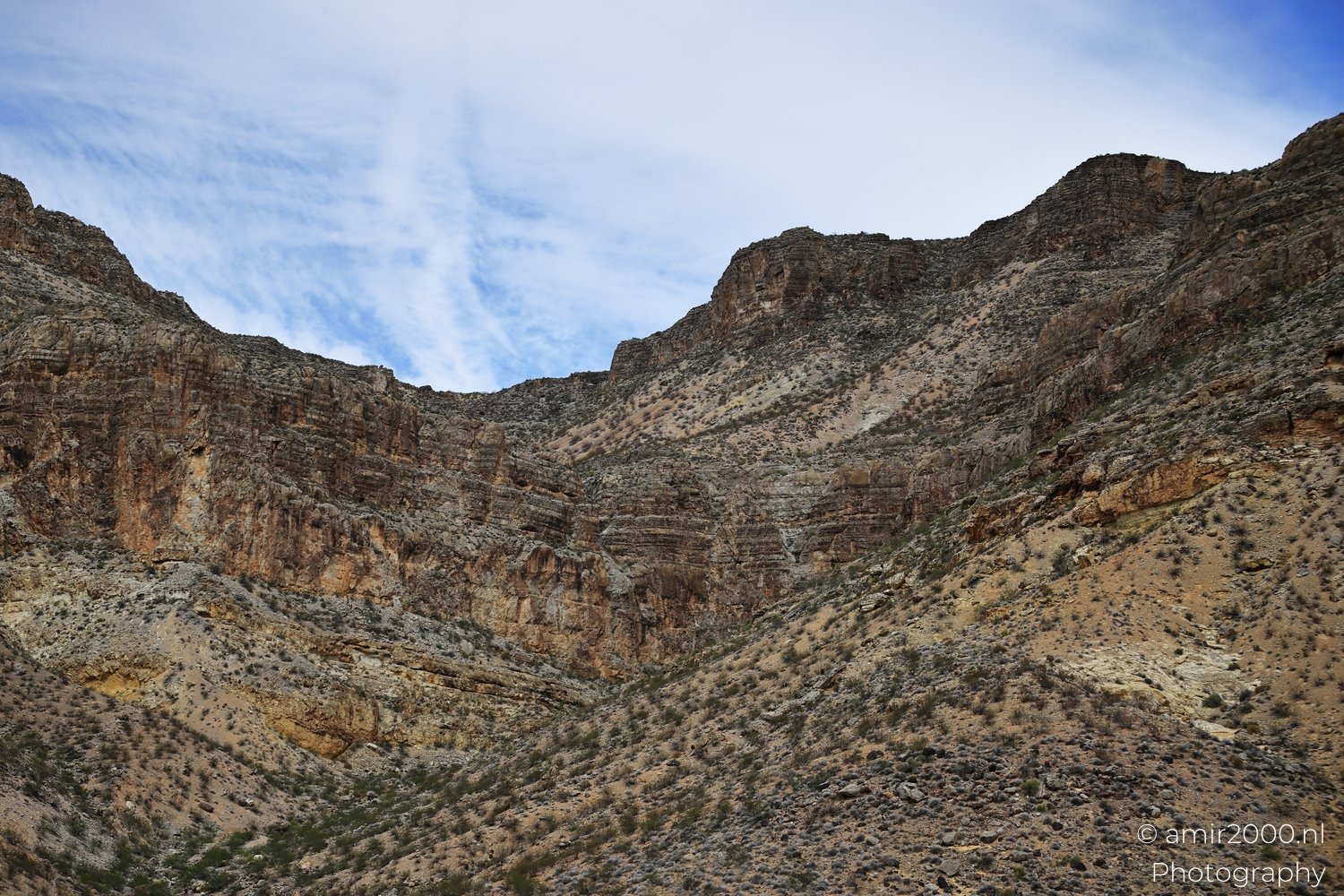 Desert view of desert landscape with dry terrain and eroded formations in Nevada USA.