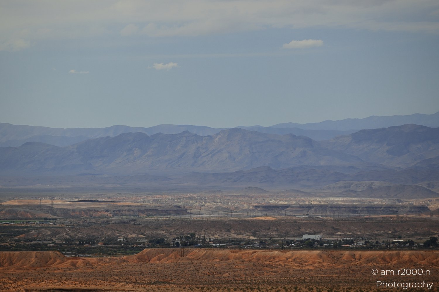 Arid-landscape view of desert landscape with canyon walls and dry ground texture in Nevada USA.
