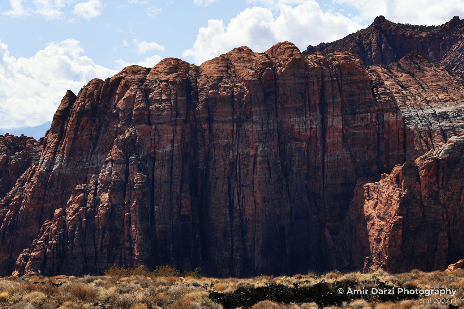 Open-desert view of canyon landscape with sunlit rock surfaces and shadow detail in St George Utah.