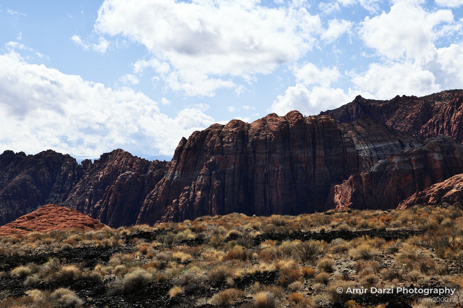 Open-desert view of canyon landscape with layered sandstone and open sky in St George Utah.