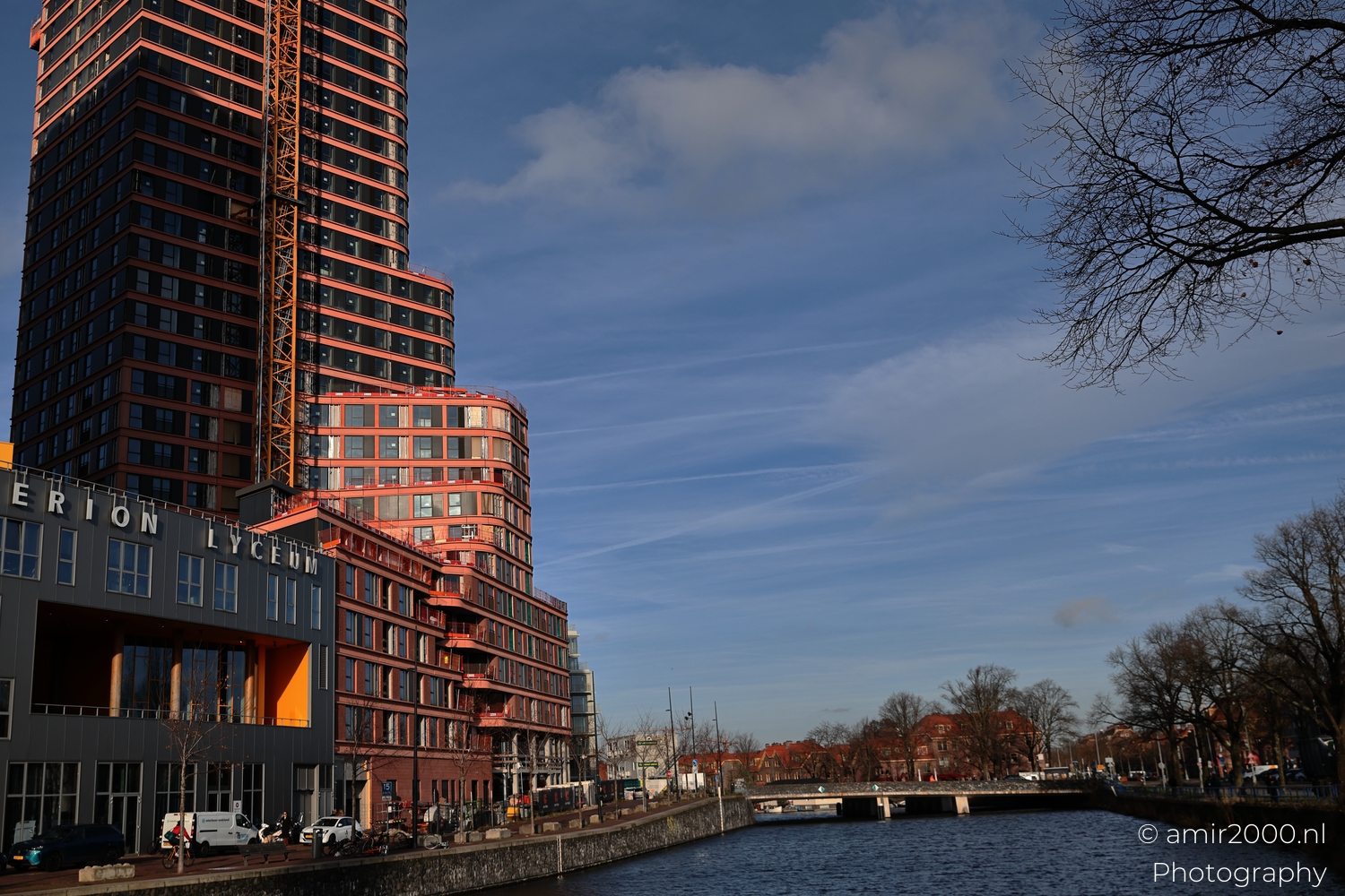 Modern high rise buildings at Badhuiskade under winter light with canal side urban context