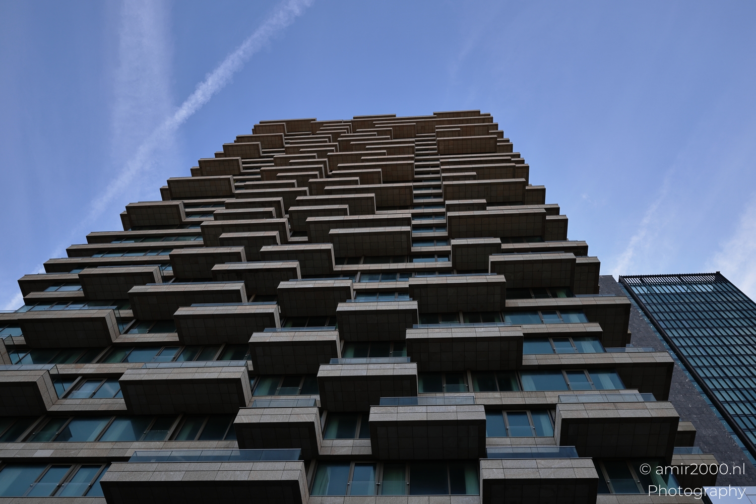 Layered residential balconies with repeating horizontal slabs and recessed glazing details