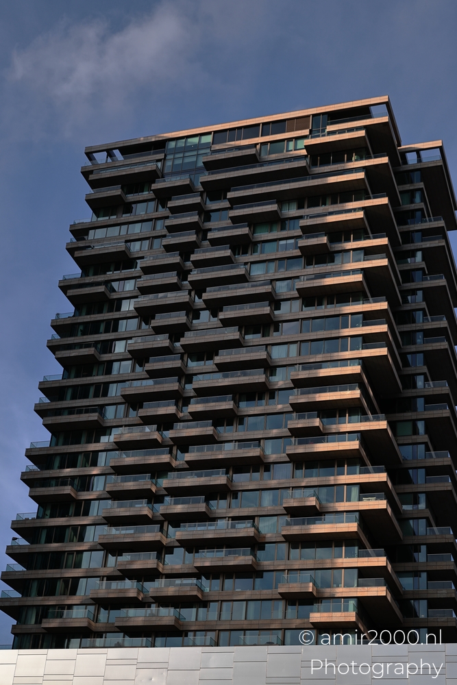 Angular Yvie balconies and layered facade pattern against bright winter sky
