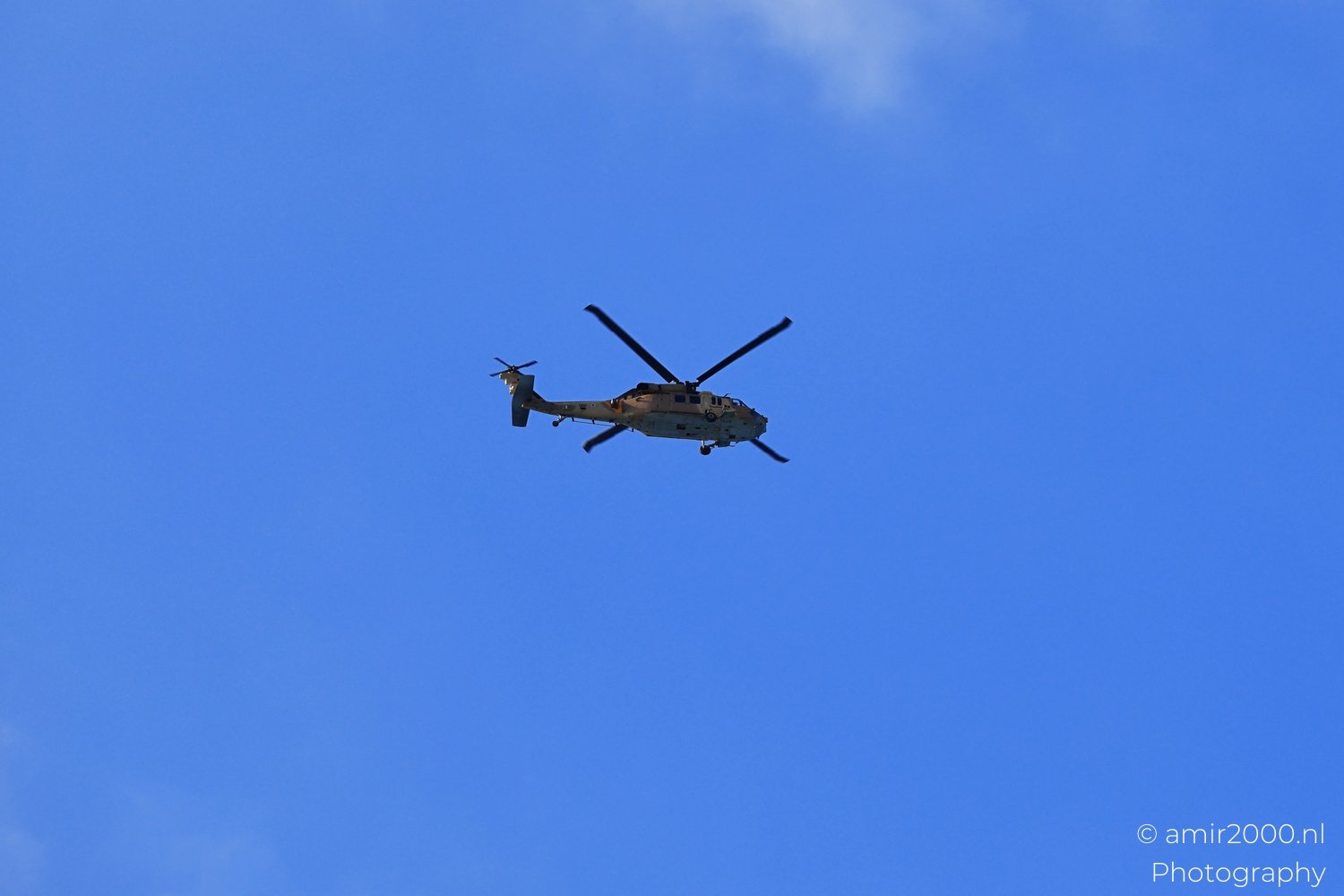Skyward view of helicopter with visible flight attitude and clean sky backdrop in Tel Aviv jaffa Israel.