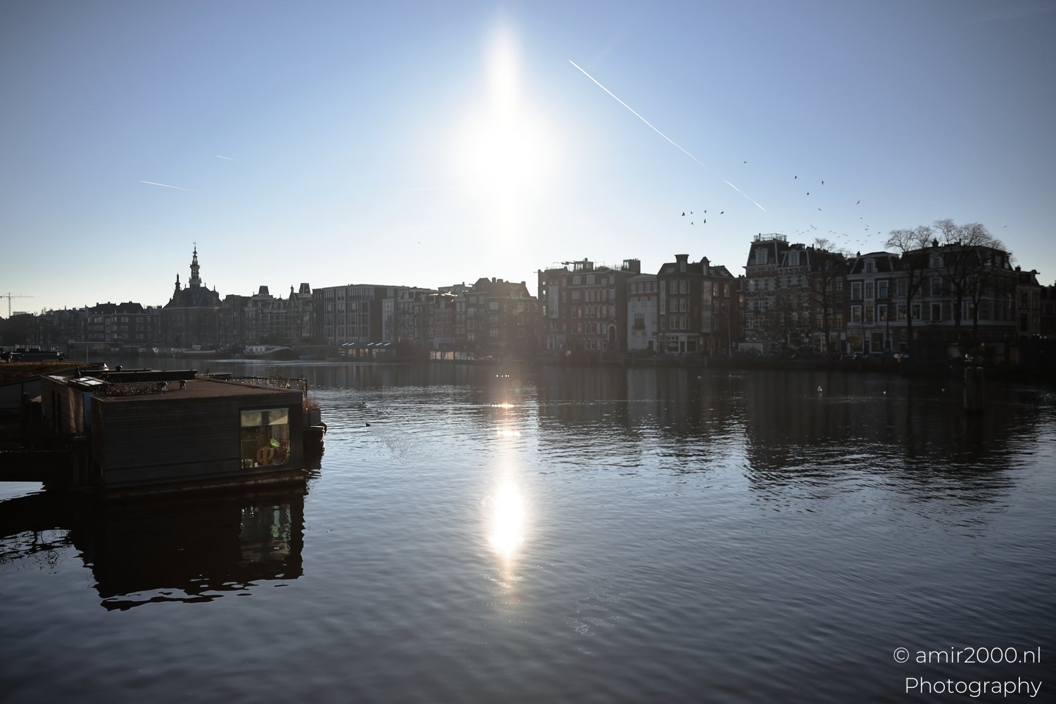 Amsterdam canal winter day low sun and reflection