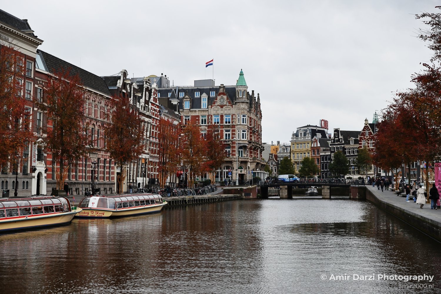 City-corridor view of with glass and concrete buildings nearby in Amsterdam Netherlands.