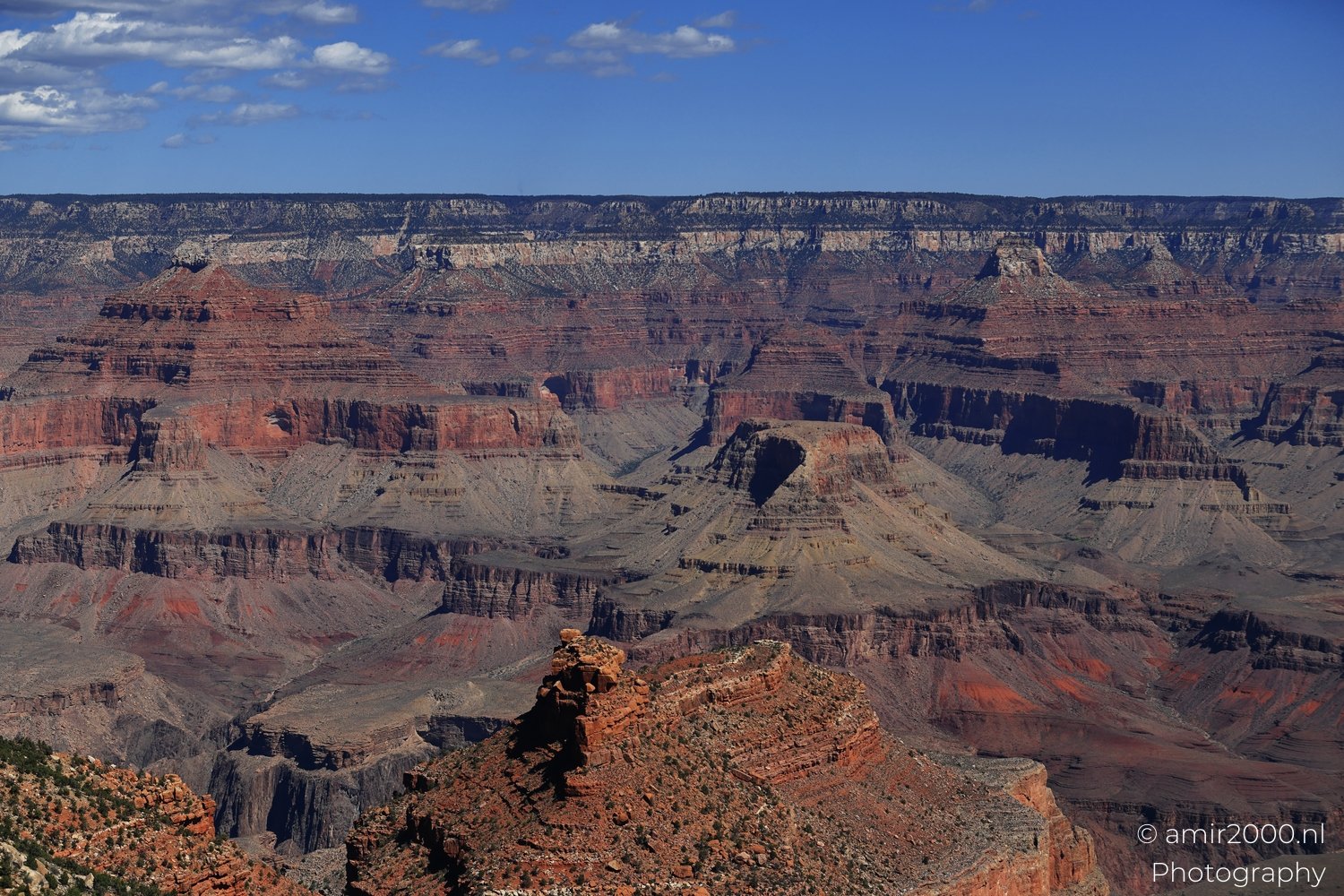 Yaki Point viewpoint deep inner canyon views with dramatic cliff shadowed walls and distant ridgelines Yaki