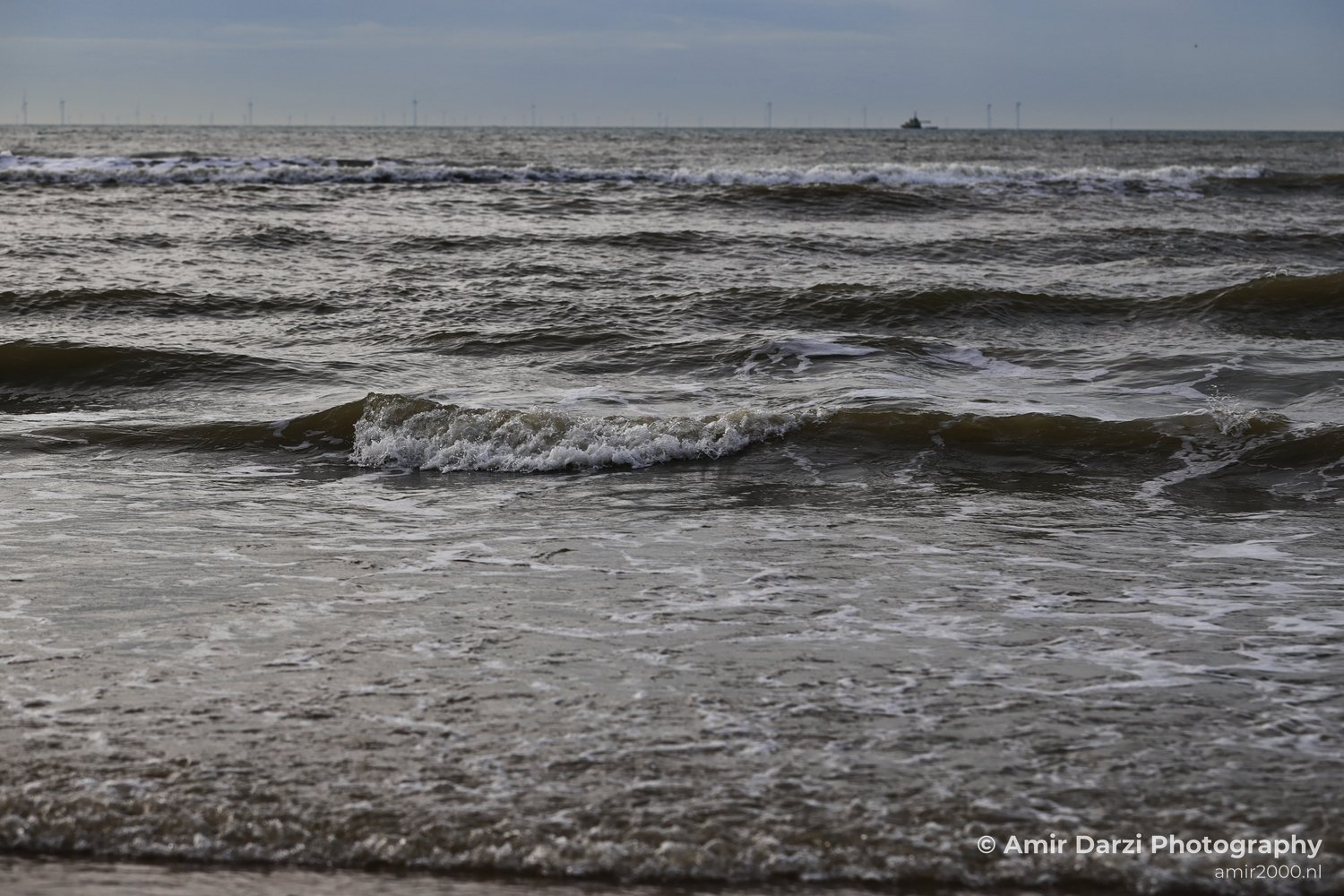 Reflected-water view of waterscape showing riverbank texture and water movement in Zandvoort Netherlands.