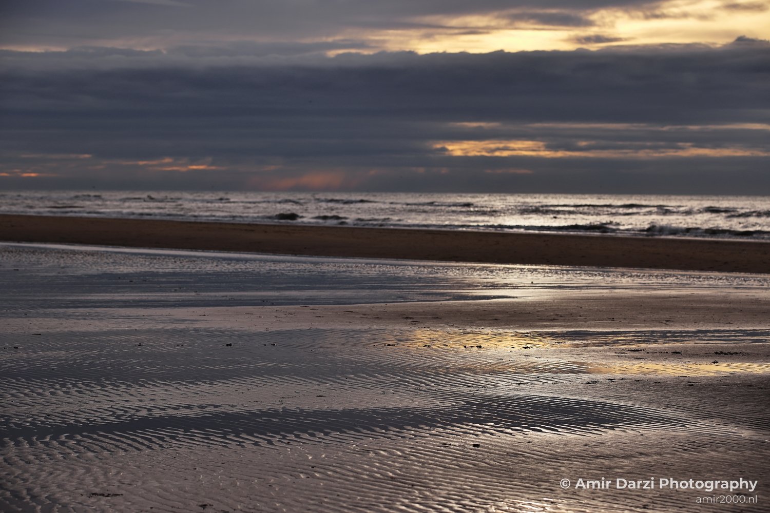 Surface-water view of waterscape with mirrored sky across open water in Zandvoort Netherlands.