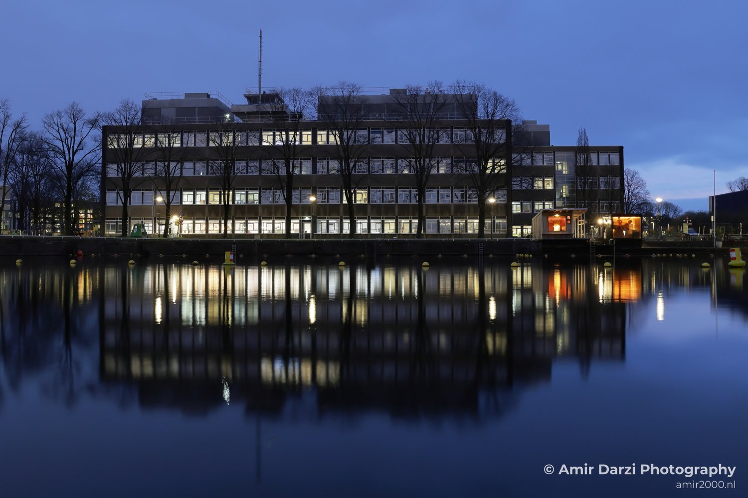 Evening-light view of nighttime scene showing evening sky gradients and silhouette detail in Amsterdam Netherlands.