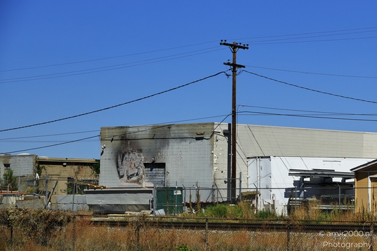 Cityscape and clear blue sky Abandoned building with graffiti and power lines in an urban setting in image from year 2025 #3