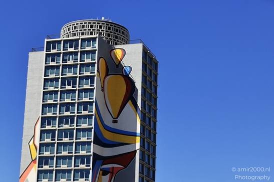 Cityscape and clear blue sky Colorful mural on the side of a building under a clear sky image from year 2025 #8