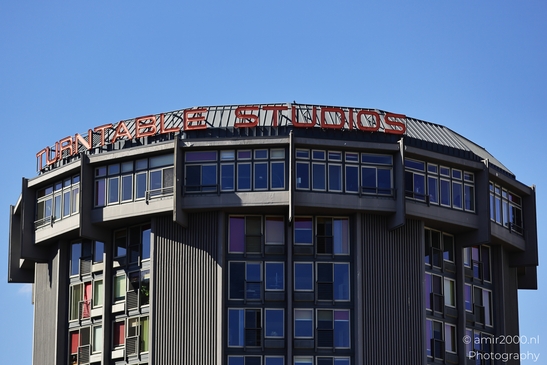 The Turntable Studios building stands prominently against a clear blue sky. - image from year 2025 #003