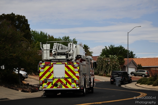 A fire engine parked on a suburban street with its extended ladder. - image from year 2025 #001