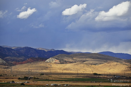 A scenic view of a rural area near Interstate 70 in Utah USA with rolling hills and mountains - image from year 2025 #002