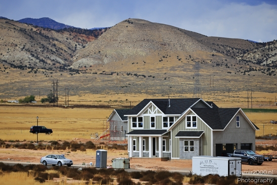 A suburban home with a garage and driveway in front of it near an interstate highway. - image from year 2025 #003