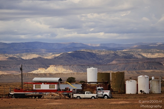 Industrial storage tanks and trailers in a rural Utah landscape. - image from year 2025 #001