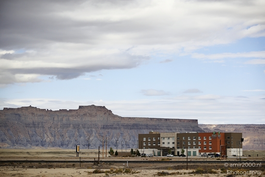 Against street signage and buildings, an crosses an intersection approach in Utah USA. - image from year 2025 #004