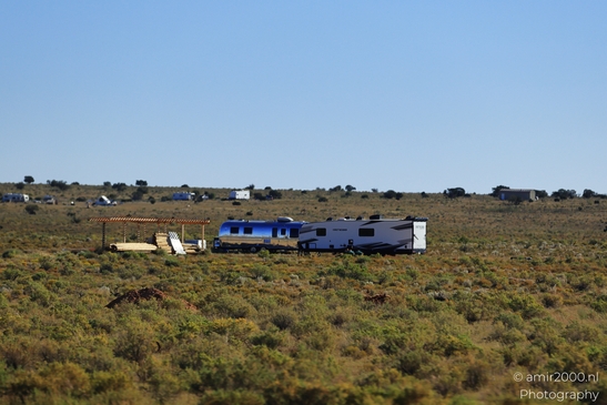 Small places on the go road trip in Arizona USA. A camper van parked in a desert landscape. - image from year 2025 #013