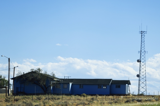 Small places on the go road trip in Arizona USA. A small blue house in a rural area of Arizona. - image from year 2025 #021