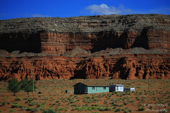 Small places on the go road trip in Arizona USA. A small house nestled among red rock formations - image from year 2025 #057