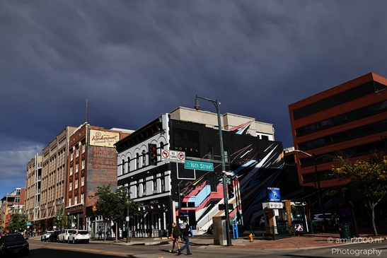 A busy street corner in Denver's downtown area with a mix of modern and historic architecture. - image from year 2025 #021