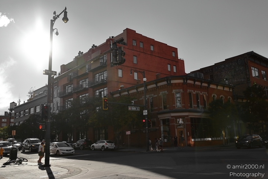 A street corner with traffic signals and a red brick industrial building in Denver. - image from year 2025 #034