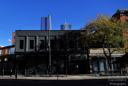 A street view of Denver's urban landscape featuring historic and contemporary buildings. - image from year 2025 #037