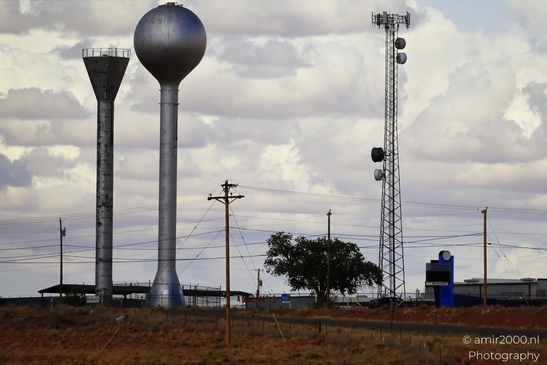 Towering Over The Desert in Arizona USA. A towering water tower in the desert, with power lines - image from year 2025 #005