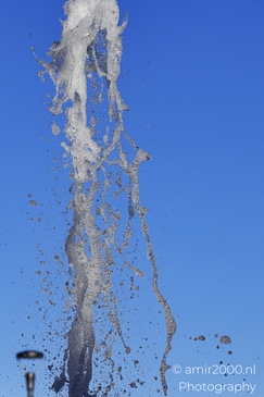 Water droplets spraying from a fountain in Outlet Colorful water splash from a fountain in Denver, image from year 2025 #2