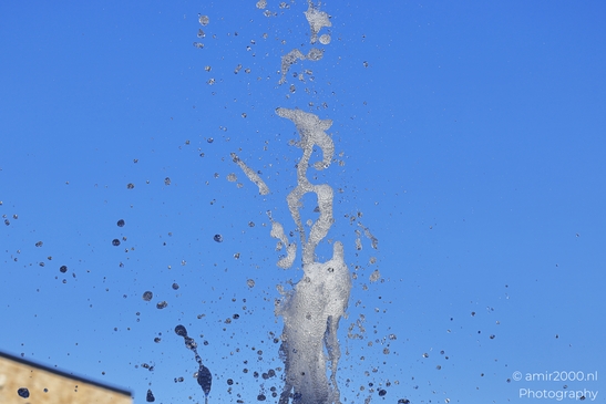 Water droplets spraying from a fountain in Outlet Splash of water droplets captured mid-air with a image from year 2025 #4