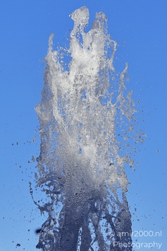 Water droplets spraying from a fountain in Outlet Water droplets captured mid-air against a clear image from year 2025 #5