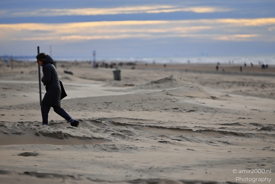 Beachgoer_In_Winter_Coat_Walking_On_Sand_Dunes_At_Dusk_Zandvoort_Netherlands_People_Creative_Collection_Photography_Canon_EOS_R5_Mark_II_2025_001.JPG