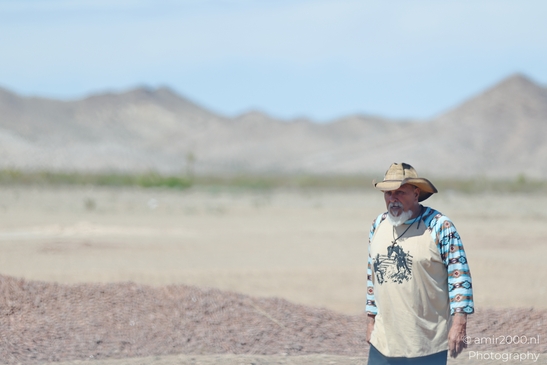 Man In Desert in Nevada USA. A man in a cowboy hat stands amidst the desert landscape of Nevada, - image from year 2025 #001