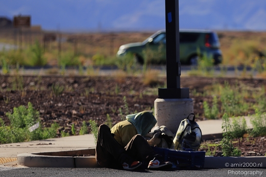 Man Sleeping On Sidewalk in Arizona USA. A man sleeps on the sidewalk in Arizona, with a - image from year 2025 #001