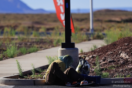 Man Sleeping On Sidewalk in Arizona USA. A man sleeps on a sidewalk in Arizona, USA. - image from year 2025 #002
