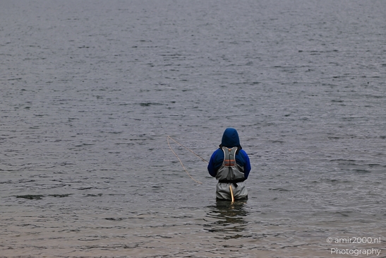 A lone fisherman stands waist-deep in Dillon Reservoir with a rod. - image from year 2025 #001
