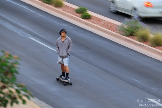 Skateboarder On Street in Sedona Arizona USA. A skateboarder cruises down a street in Sedona, - image from year 2025 #001