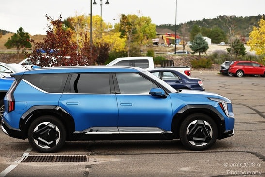 A vibrant blue SUV parked in a parking lot with distinctive wheels. - image from year 2025 #012