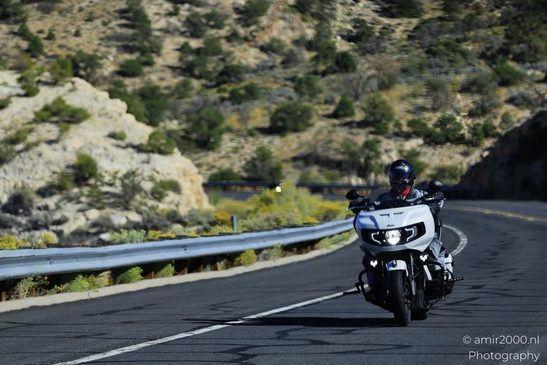 Motorcycle Ride Through Desert in Transportation Collection. A lone motorcyclist navigates the - image from year 2025 #001