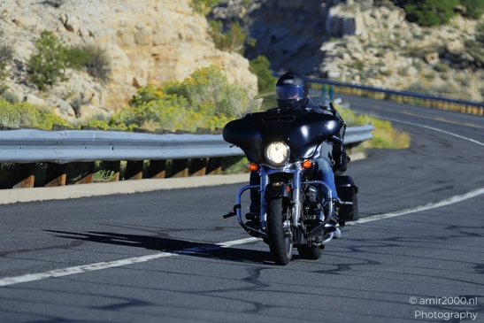 Motorcycle Ride Through Desert in Transportation Collection. A lone motorcyclist rides through - image from year 2025 #002