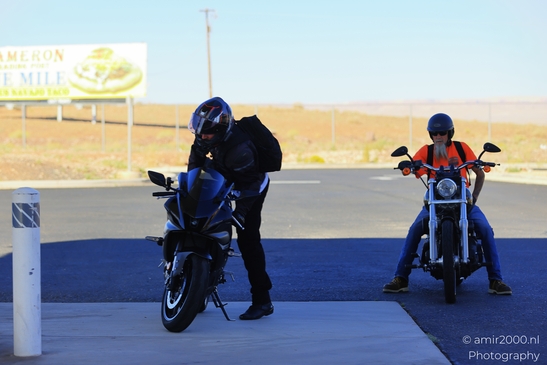 Motorcycle Ride Through Desert in Transportation Collection. Two motorcyclists pause for a - image from year 2025 #003